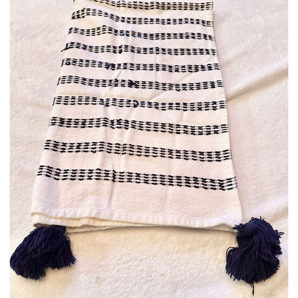 Navy and white stitched towel with Pom Pom’s